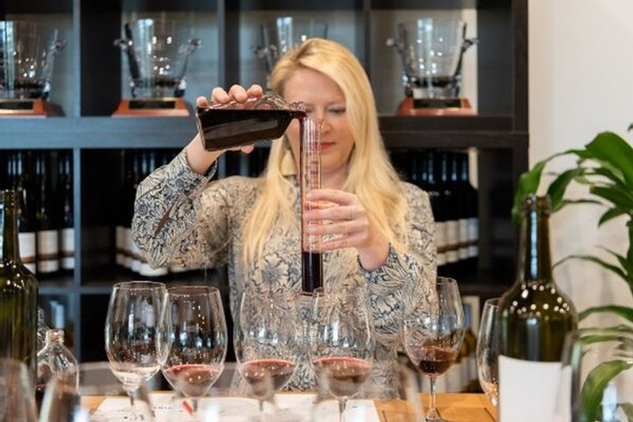 Person pouring wine into wine glass at Wine House Hunter Valley